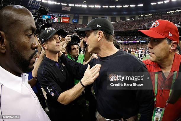 Head coach Jim Harbaugh of the San Francisco 49ers congratulates his brother head coach John Harbaugh of the Baltimore Ravens after the Ravens won...