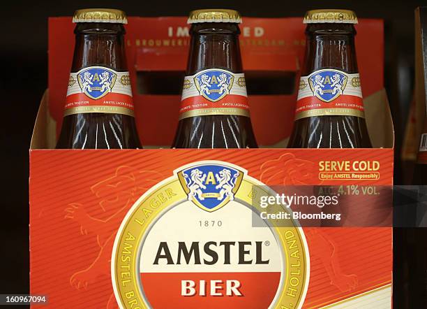 Bottles of Amstel lager beer, produced by Heineken NV, sit on display inside a supermarket in London, U.K., on Friday, Feb. 8, 2013. Britain's...