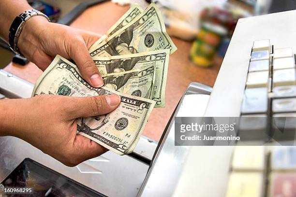 store cashier counting the cash - 20 dollars stock pictures, royalty-free photos & images