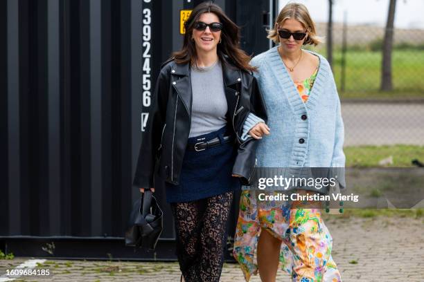 Francesca Saffari wears black leather jacket, bag, laced skirt, mini skirt & Hollie Mercedes Peters wears blue cardigan, skirt with floral print, bag...