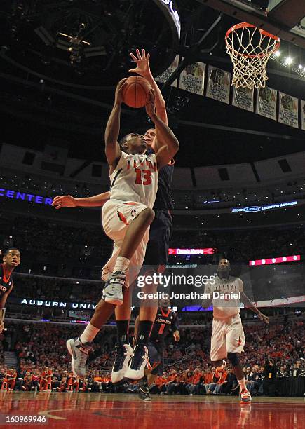 Tracy Abrams of the Illinois Fighting Illini goes up against Rob Chudd of the Auburn Tigers at United Center on December 29, 2012 in Chicago,...