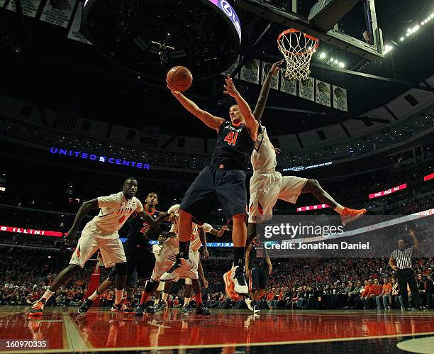 Rob Chubb of the Auburn Tigers grabs a rebound away from Noel Johnson of the Illinois Fighting Illini at United Center on December 29, 2012 in...