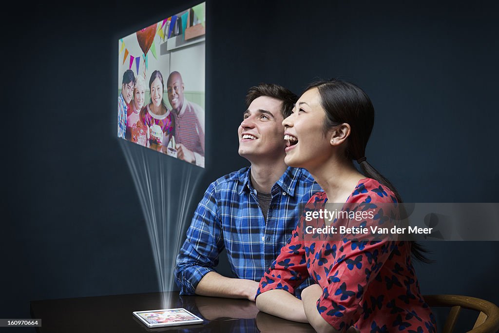 Couple looking at projected digital image...