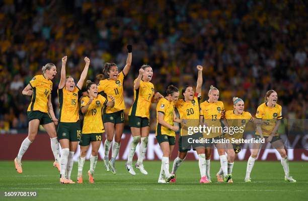 Players of Australia celebrate as Mackenzie Arnold of Australia saves the first penalty of France from Selma Bacha of France in the penalty shoot out...