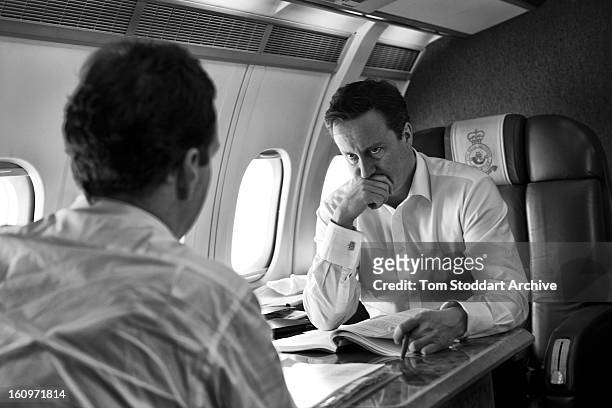 Prime Minister David Cameron deep in thought over Europe as he listens to Chancellor George Osborne during the flight taking them to attend the G20...