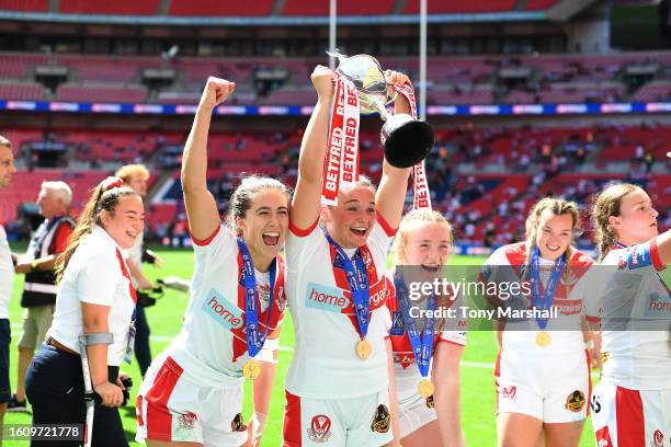 Eboni Partington of St Helens celebrates their win with the troph during Betfred Women's Challenge Cup Final match between St Helens and Leeds Rhinos...