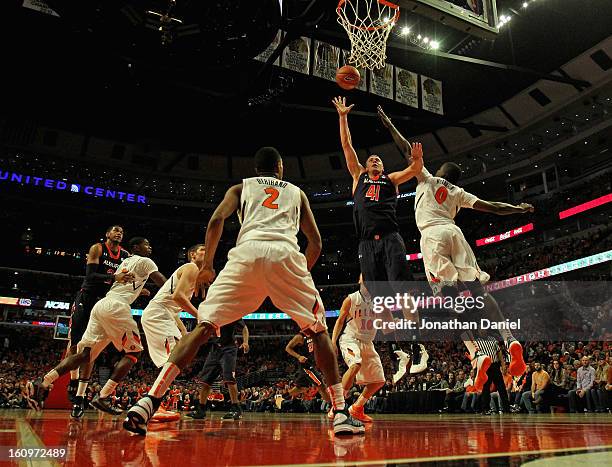 Rob Chubb of the Auburn Tigers shoots between Sam McLaurin and Myke Henry of the Illinois Fighting Illini at United Center on December 29, 2012 in...
