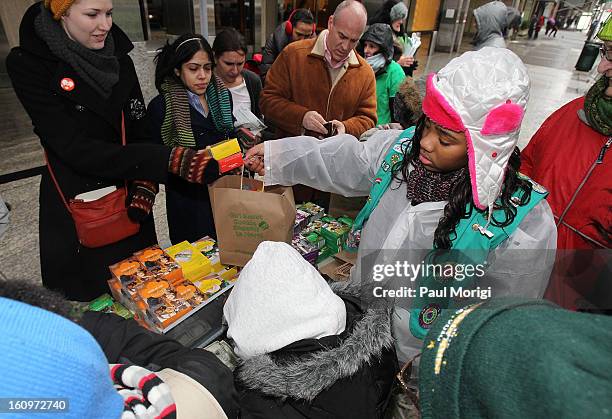 Girl Scouts sell cookies in support of the world’s largest girl-led business during National Girl Scout Cookie Day on February 8, 2013 in New York...
