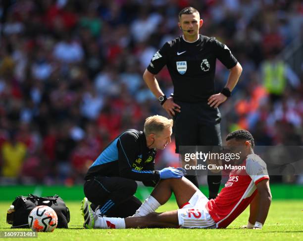 Jurrien Timber of Arsenal receives medical treatment during the Premier League match between Arsenal FC and Nottingham Forest at Emirates Stadium on...