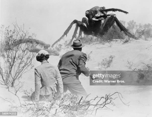 American actor James Arness protects actress Joan Weldon from a giant mutant killer ant in a scene from the film 'Them!', 1954.