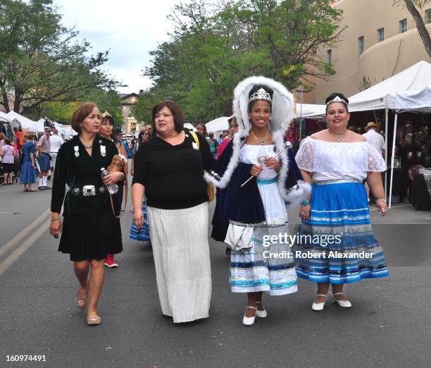 The queen of the 2012 Santa Fe Fiesta , Jenae Monique Cisneros y Roybal , walks with the Fiesta's princesses and others down a Santa Fe street during...