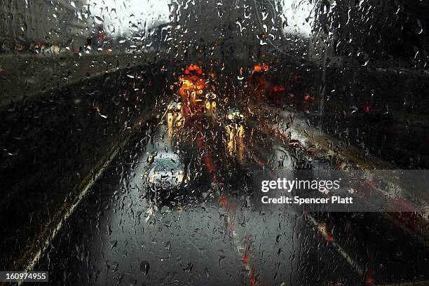 Cars are viewed through a window as they drive in the rain and sleet as Manhattan prepares for a major winter storm on February 8, 2013 in New York...