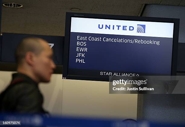 United Airlines customer lines up to rebook a flight that was canceled due to weather on February 8, 2013 in San Francisco, California. Thousands of...