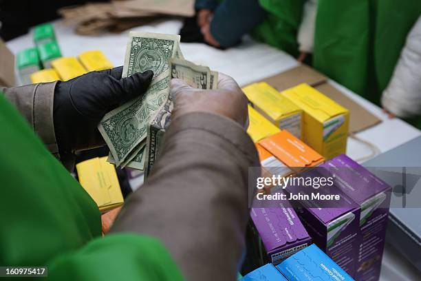 MOney is collected as Girl Scouts sell cookies while a winter storm moves in on February 8, 2013 in New York City. The scouts did brisk business,...