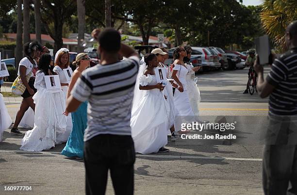 College students wear wedding gowns as they participate in the College Bride's Walk from Barry University on February 8, 2013 in Miami Shores,...