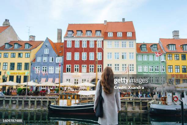 woman enjoying her trip to copenhagen, denmark - copenhagen nyhavn stock pictures, royalty-free photos & images
