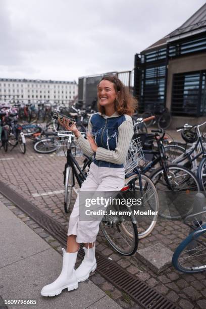 Johanne Krebs seen wearing light green / denim cardigan, white / beige midi cargo shorts and Copenhagen Studios CPH500 Vitello White leather boots,...