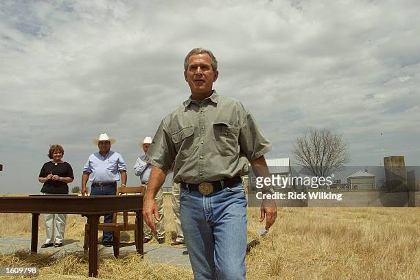 President George W. Bush walks away from a platform August 13, 2001 after signing legislation authorizing $5.5 billion US dollars in farm bailout...