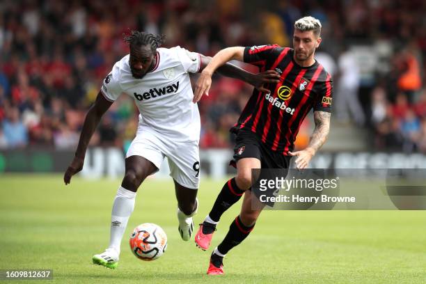 Michail Antonio of West Ham United and Marcos Senesi of AFC Bournemouth battle for possession during the Premier League match between AFC Bournemouth...