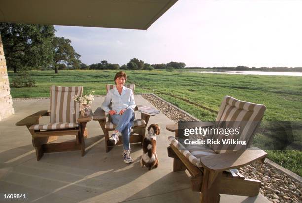 First Lady Laura Bush, wife of President George W. Bush is relaxing in an Adirondack chair April 11, 2001 on the patio outside of the house at their...