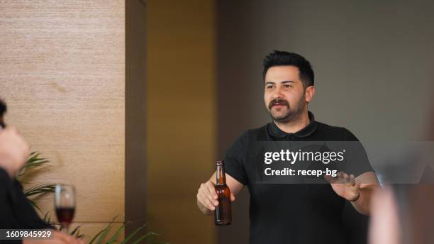 cheerful businessman giving small speech and toasting with collages during business party gathering - glass bottle white bg stock pictures, royalty-free photos & images