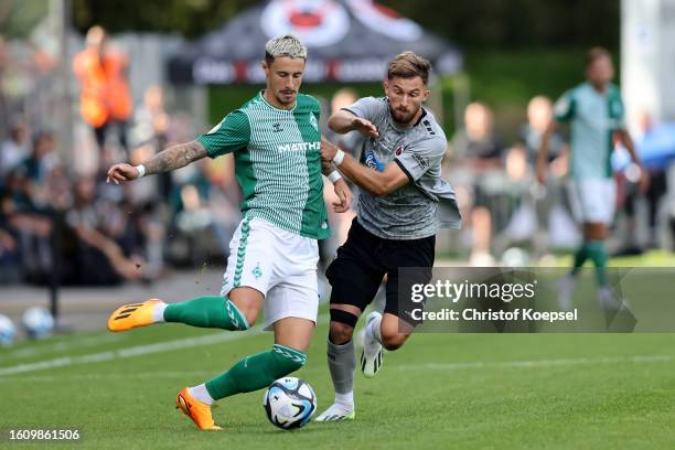 Valdrin Mustafa of Viktoria Koeln challenges Marco Friedl of Bremen during the DFB cup first round match between Viktoria Köln and Werder Bremen at...