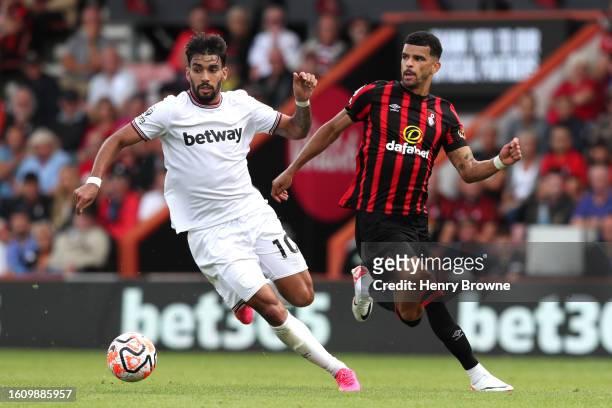Lucas Paqueta of West Ham United runs with the ball whilst under pressure from Dominic Solanke of AFC Bournemouth during the Premier League match...