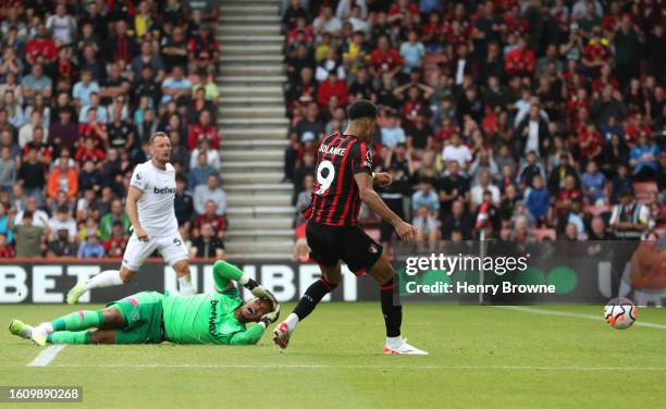 Dominic Solanke of AFC Bournemouth scores the team's first goal as Alphonse Areola of West Ham United reacts during the Premier League match between...