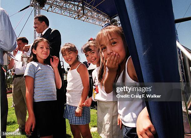 Christina Estrada, Jasmine Gutierrez, Amanda Sanchez and her cousin Angelika Sanchez share a laugh as they wait to greet Mayor Wellington Webb...