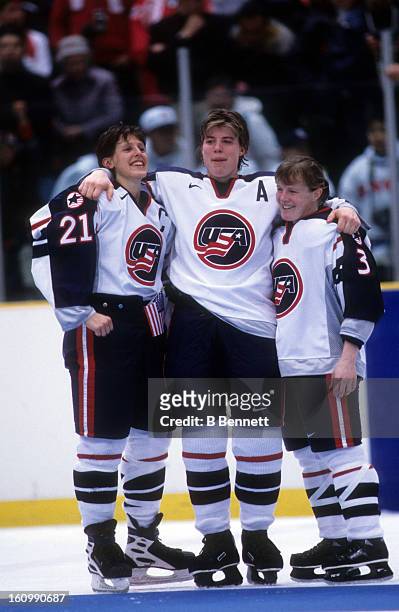 Cammi Granato, Karyn Bye and Lisa Brown-Miller of Team USA celebrate on the ice after the women's gold medal match against Team Canada at the 1998...