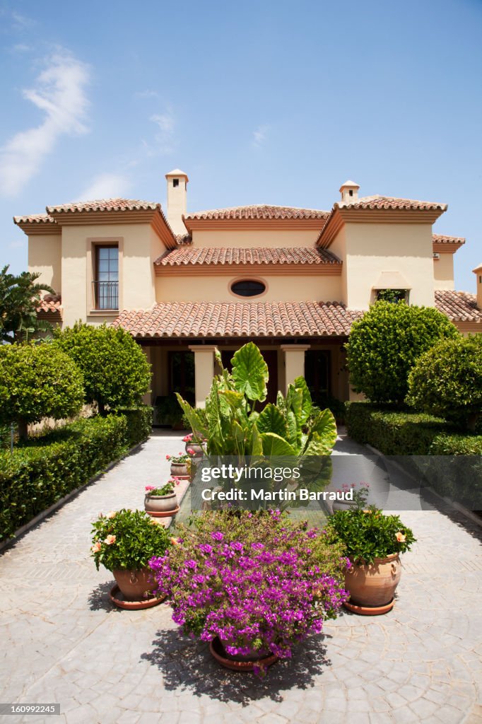 Potted plants in formal garden outside villa