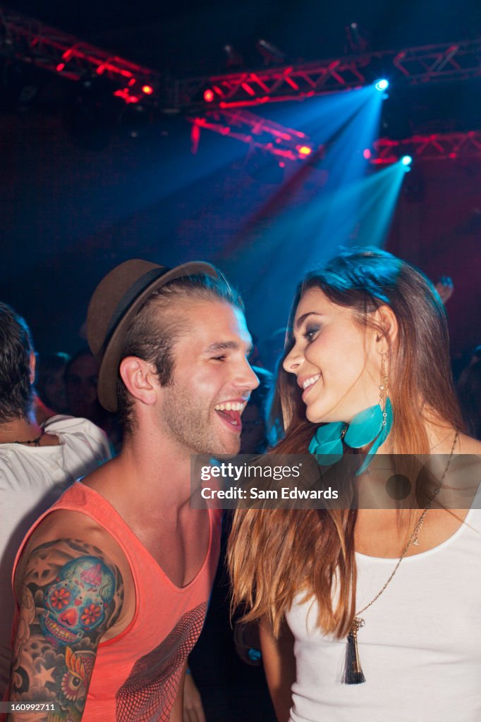 Smiling couple dancing at nightclub