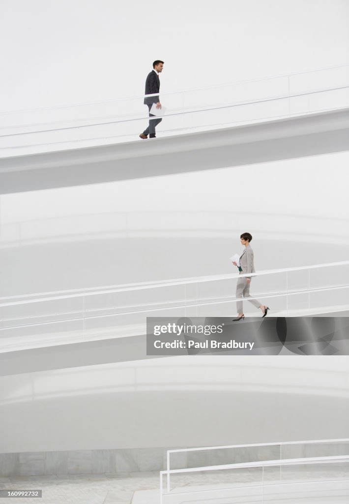 Business people walking on elevated walkways