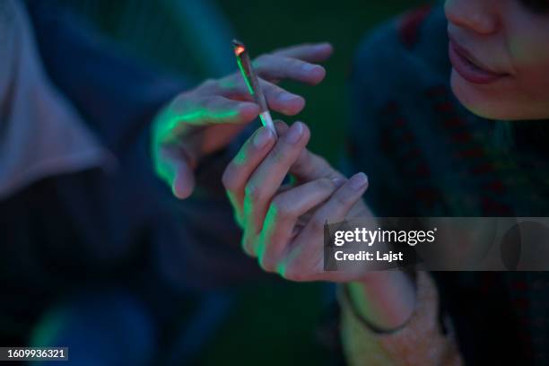 two lesbian women smoke marijuana, close-up - cannabis plant stock pictures, royalty-free photos & images