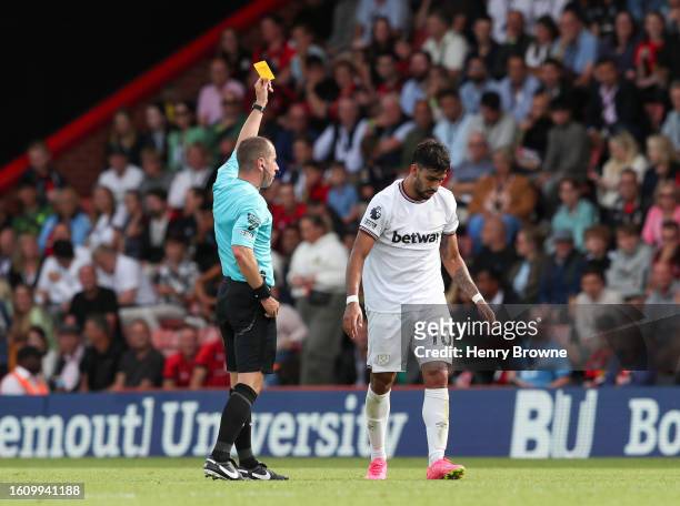 Referee Peter Bankes shows a yellow card to Lucas Paqueta of West Ham United during the Premier League match between AFC Bournemouth and West Ham...