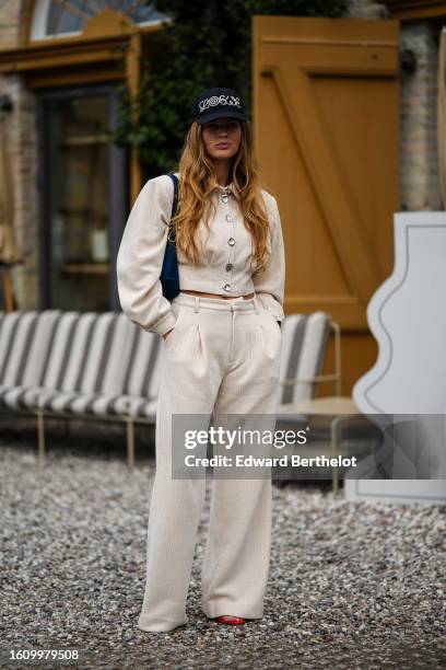 Guest wears a beige embossed striped print pattern shirt neck / long sleeves cropped jacket, matching beige embossed striped print pattern wide legs...