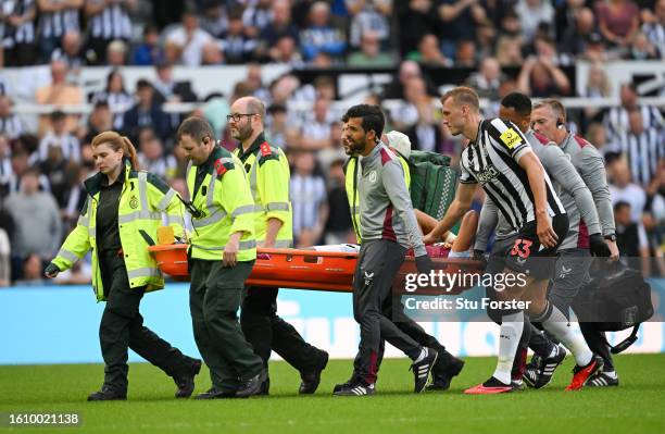 Tyrone Mings of Aston Villa leaves the field on a stretcher after sustaining an injury during the Premier League match between Newcastle United and...