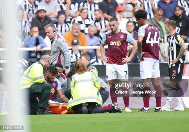 Tyrone Mings of Aston Villa looks dejected after sustaining an injury during the Premier League match between Newcastle United and Aston Villa at St....