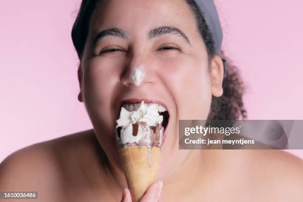 happy woman eating an ice cream cone - glace cornet stock pictures, royalty-free photos & images