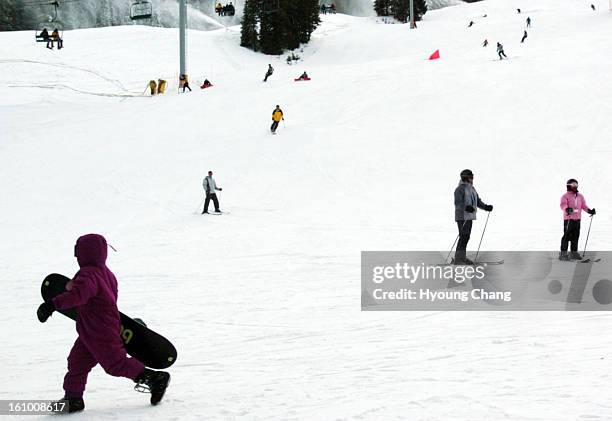 Young snowboarder, left corner, is heading to lift chair at Copper Moutnain ski resort on Tuesday.