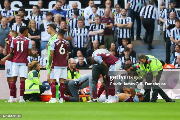 Tyrone Mings of Aston Villa is stretchered off with an injury during the Premier League match between Newcastle United and Aston Villa at St. James...