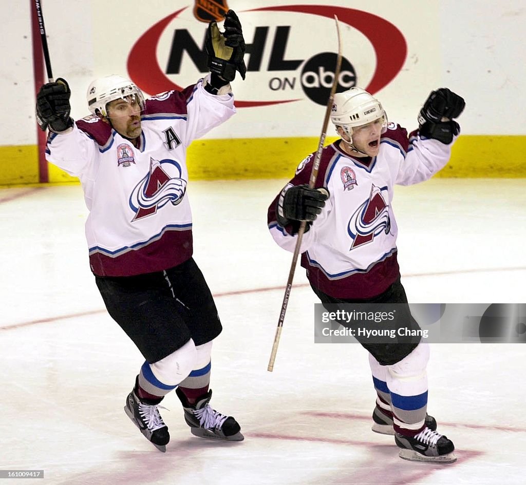 Avalanche #77 Ray Bourque, (L) and #40 Alex Tanguay (R) skate to congratulate Joe Sakic on his second period goal. Sakic's goal put the avs up 3-0 in the 7th game of the Stanley Cup finals in Denver. Photo by Hyoung Chang