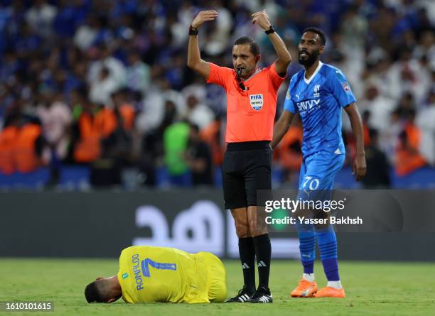 Cristiano Ronaldo of Al Nassr goes down with an injury during the Arab Club Champions Cup Final between Al Hilal and Al Nassr at King Fahd...