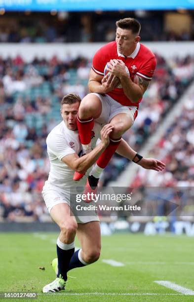 Josh Adams of Wales is tackled in mid-air by Freddie Steward of England whilst attempting to catch a cross-field kick, which later results in a...