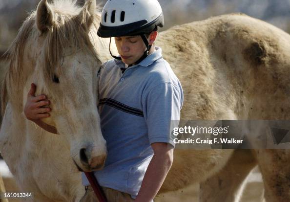 FEBRUARY 10, 2005 - RIFLE, CO- 16-year-old Josh comforts his favorite horse, dash, before starting his chores while taking part in the Equine therapy at the Emily Griffith Center in Rifle, CO. The 24 hour residential facility for boy that have been abused FEBRUARY 10, 2005 - RIFLE, CO- 16-year-old Josh comforts his favorite horse, dash, before starting his chores while taking part in the Equine therapy at the Emily Griffith Center in Rifle, CO. The 24 hour residential facility for boy that have been abused