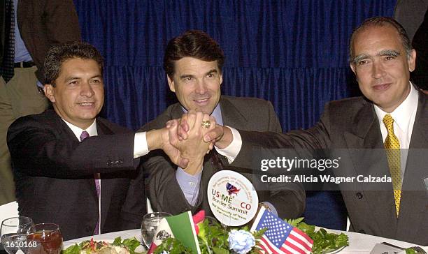 Governor Tomas Yarrington of the state of Tamaulipas, Mexico, Texas Governor Rick Perry and Nuevo Leon Governor Fernando Canales Clariond join hands...