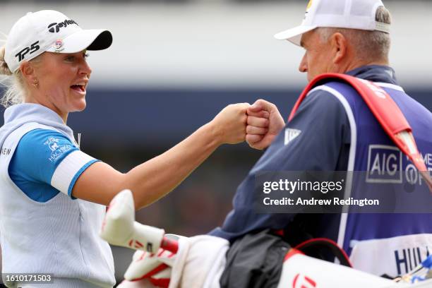 Charley Hull of England fist bump her caddie after fininshing her round on the 18th hole on Day Three of the AIG Women's Open at Walton Heath Golf...