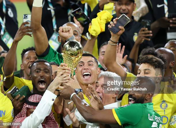 Cristiano Ronaldo of Al Nassr lifts the Arab Club Champions Cup trophy with teammates after the team's victory in the Arab Club Champions Cup Final...