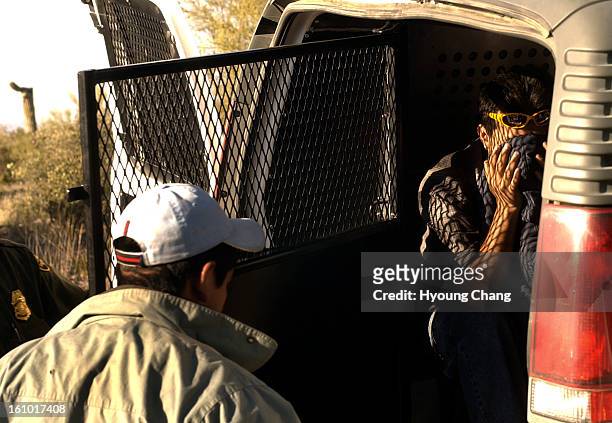 Boader Patrol officers put the undocumented immigrants into the van by Hwy 86 in the Tohono O'Odham Indian reservation on Monday. A Community in...