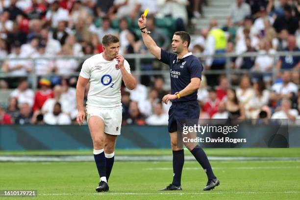 Owen Farrell of England reacts after receiving a yellow card from Referee Nika Amashukeli after a high tackle on Taine Basham of Wales during the...